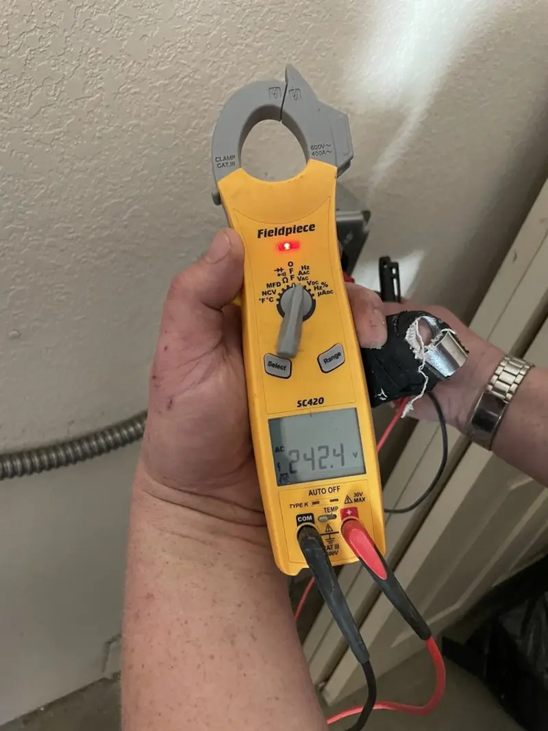 Voltage testing with clamp meter during Outlet Installation in Astoria